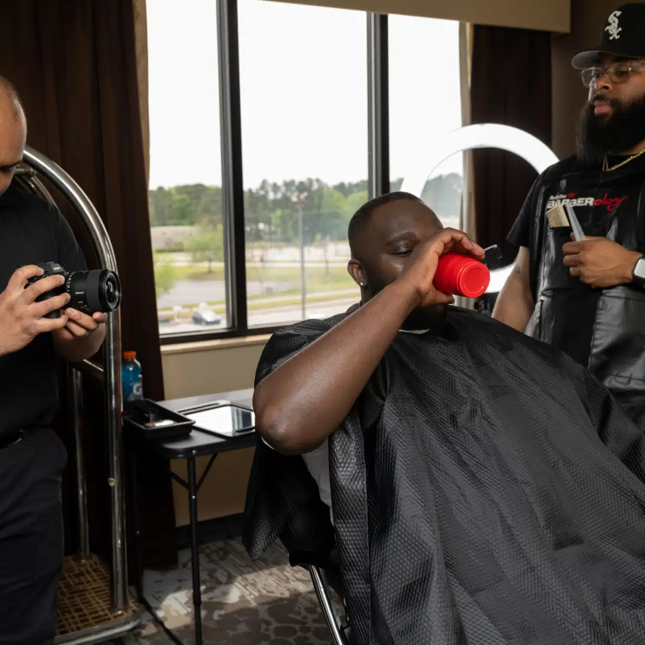 Groom getting his hair cut for his wedding and going through the wedding process with all of his groomsmen. While the videographer is capturing candid moments for the groomsmen