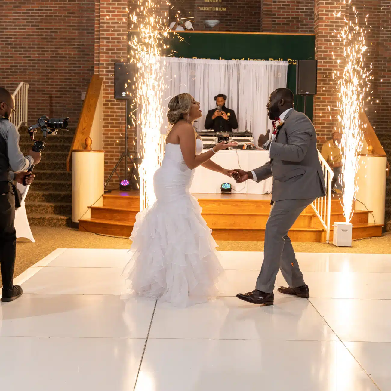 Dontavious Chesson of True Essence Photography, using a ronin rs3 pro to capture the bride's and groom's first wedding dance and celebration. Located in raleigh, nc wedding venue. Sparks flying in the background for the first dance.