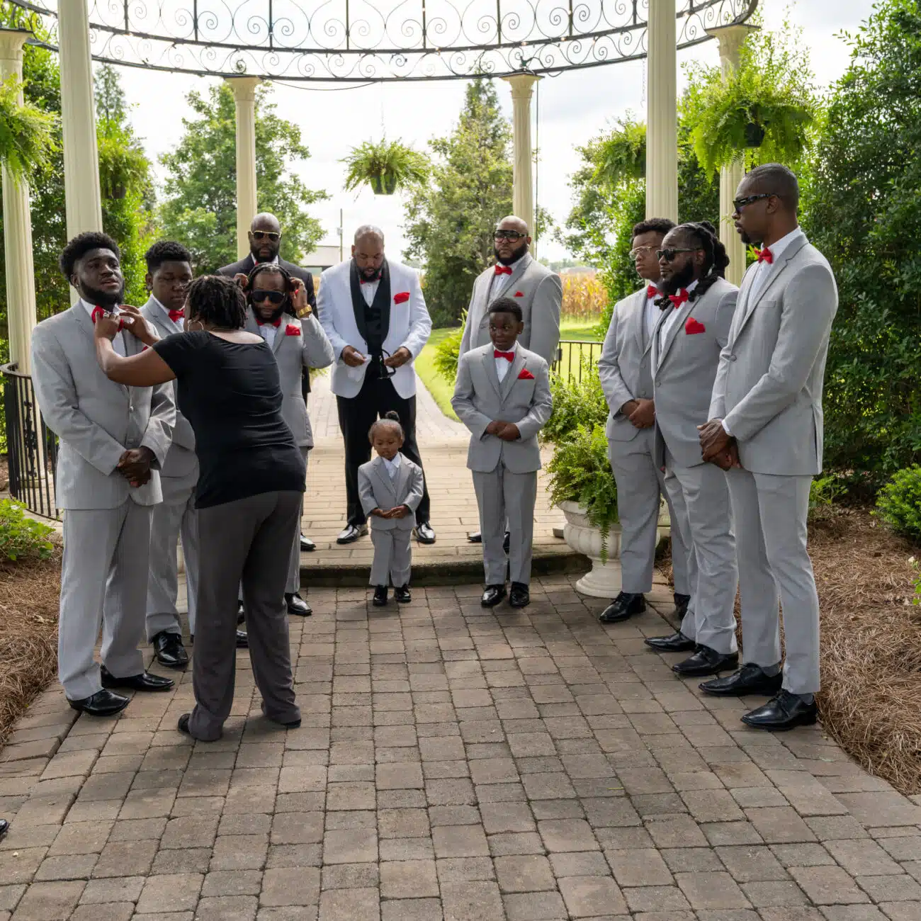 Toyette Anthony positing the groomsmen according to the wedding planning process that was set prior to the wedding day itself.