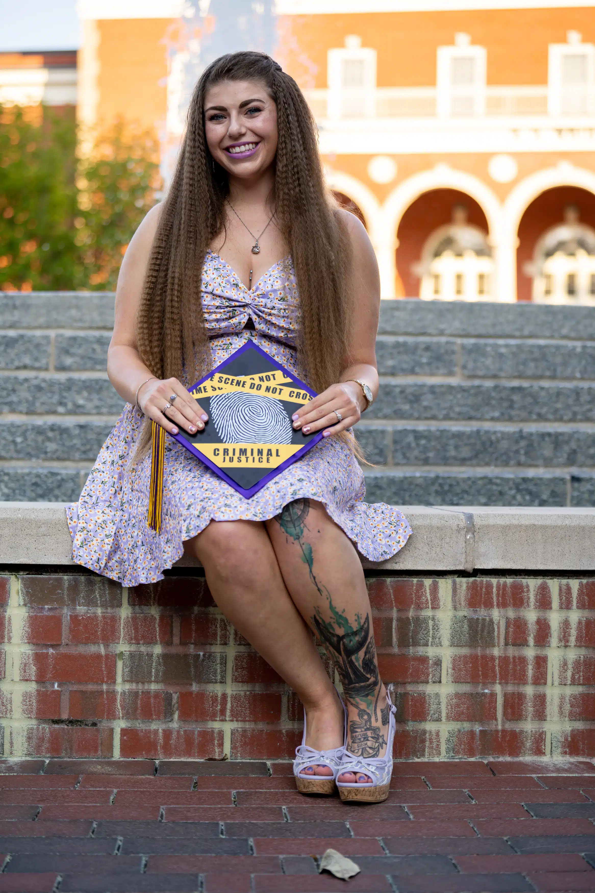 Woman holding her custom cap for her graduation photos
