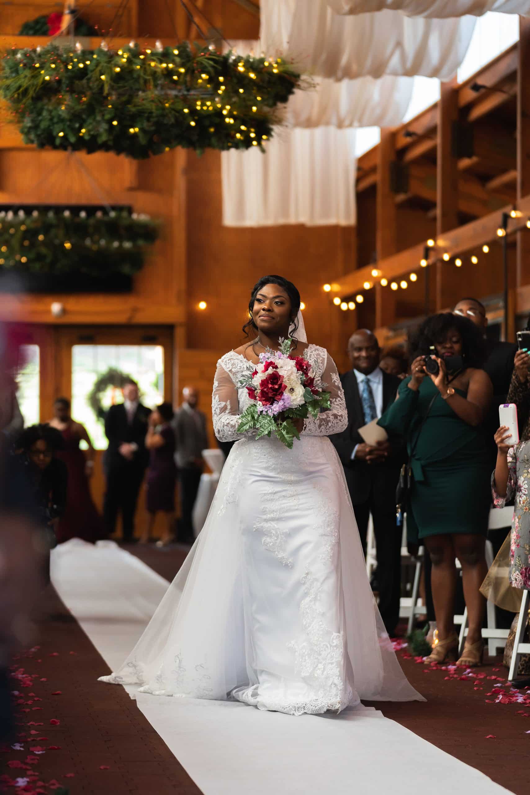 Bride walking down the aisle for the first time at a wedding venue in Raleigh, NC take by greenville, nc wedding photographer